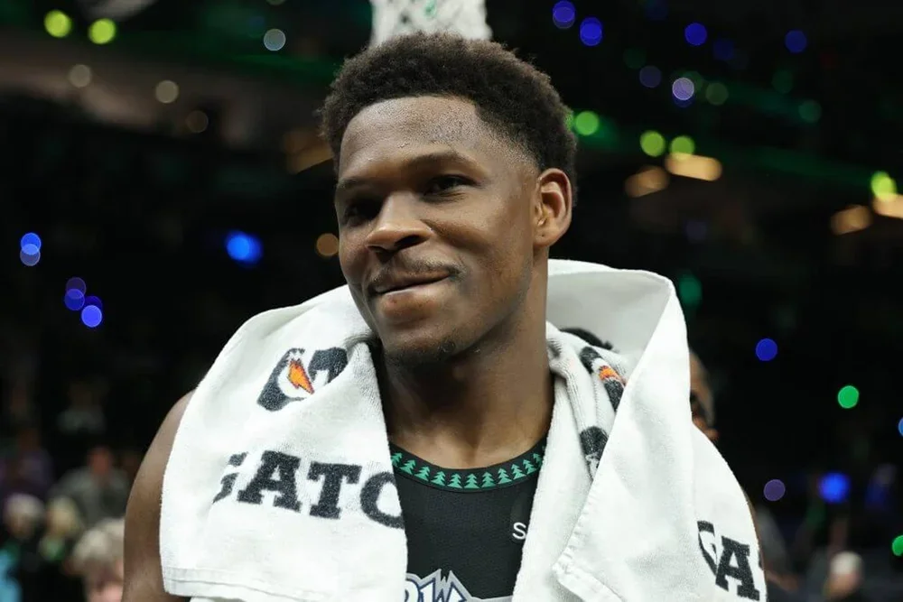 Anthony Edwards smiles with a towel around his neck after the Timberwolves' win in Game 4 on Sunday.
